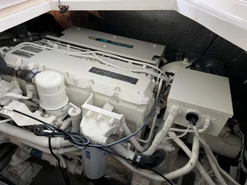 Slide: The Image of Engine compartment of a 2000 Cruisers Yachts 4270 Express, showcasing detailed mechanical components. - 41