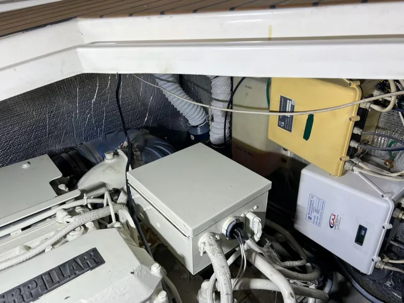 Slide: The Image of Engine room of 2000 Cruisers Yachts 4270 Express with visible machinery and wiring. - 43