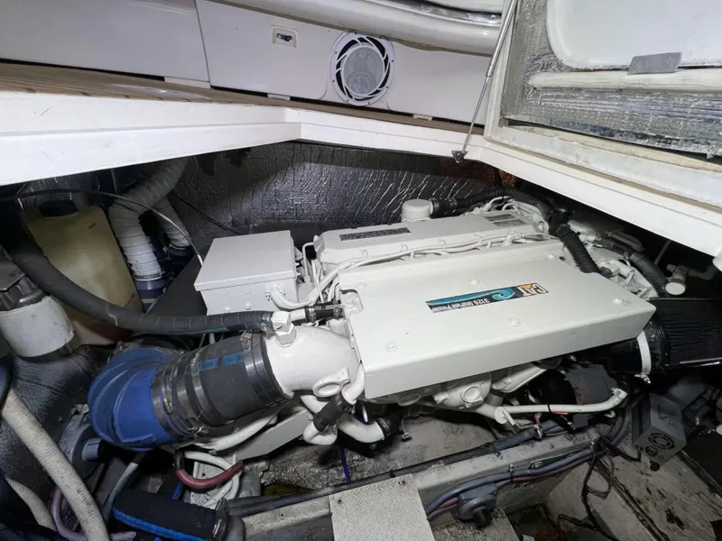 Slide: The Image of Engine room of 2000 Cruisers Yachts 4270 Express, showcasing marine engine components. - 44