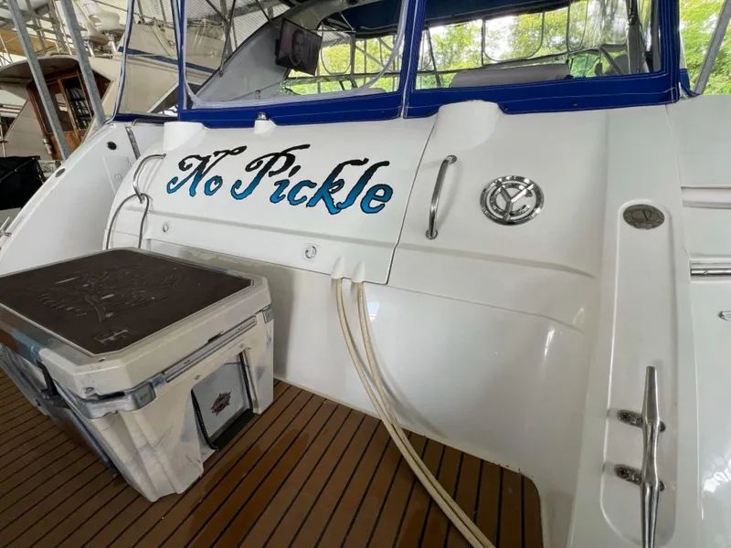 Slide: The Image of 2000 Cruisers Yachts 4270 Express with "No Pickle" name on the stern, docked. - 9