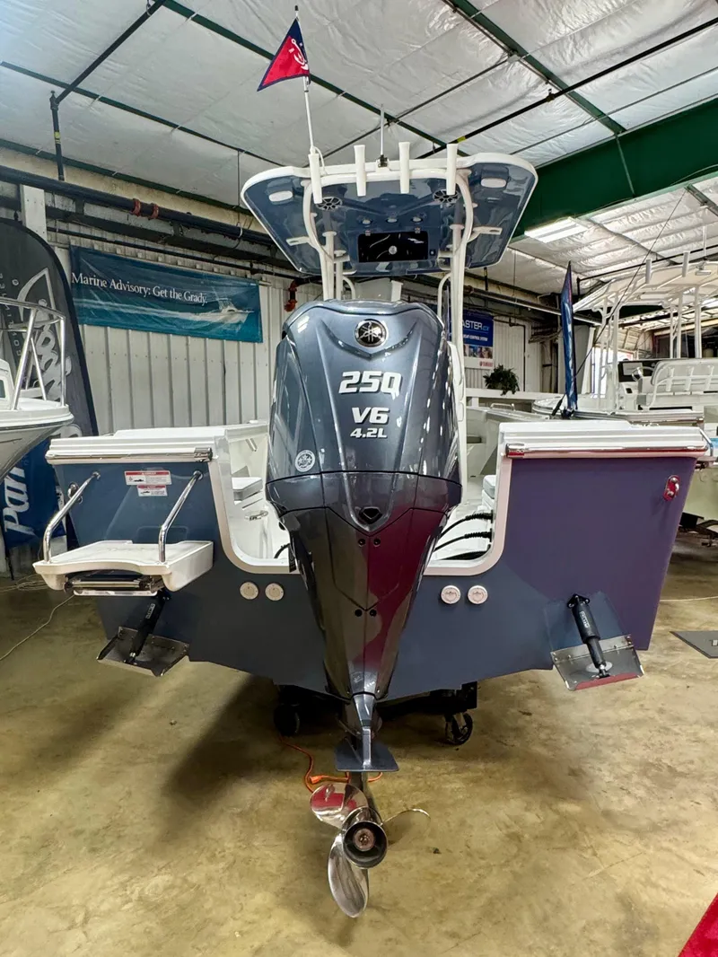 Slide: The Image of 2025 Parker 23SE Center Console boat with 250 V6 engine in a showroom. - 3