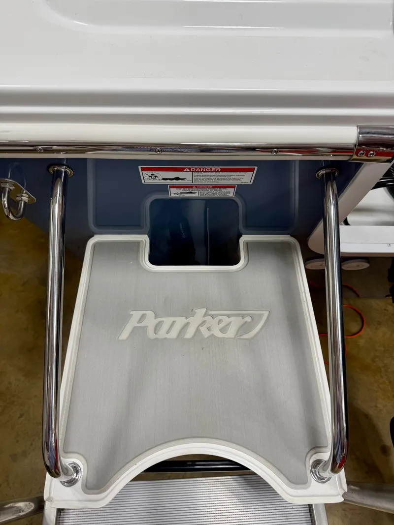 Slide: The Image of 2025 Parker 23SE Center Console boat step with logo and stainless steel rails. - 5