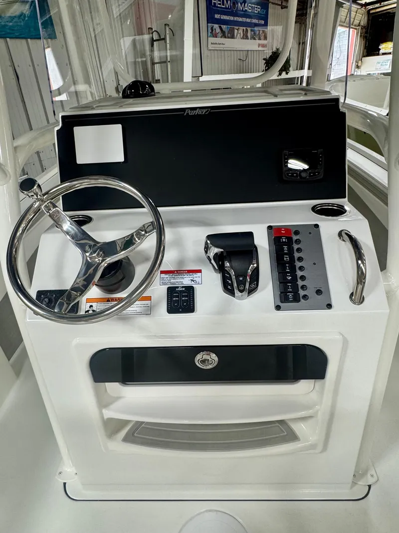 Slide: The Image of 2025 Parker 23SE Center Console boat dashboard with steering wheel and control panel. - 8
