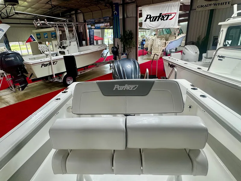 Slide: The Image of 2025 Parker 23SE Center Console boat displayed indoors with red carpet and banners. - 9