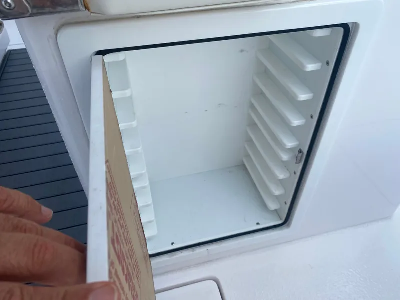 Slide: The Image of Open storage compartment on a 2022 Front Runner 36 cc boat. - 10