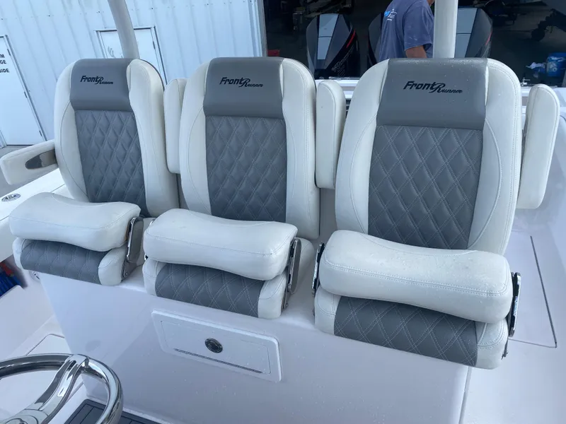 Slide: The Image of 2022 Front Runner 36 cc boat seats with gray and white diamond stitching. - 11