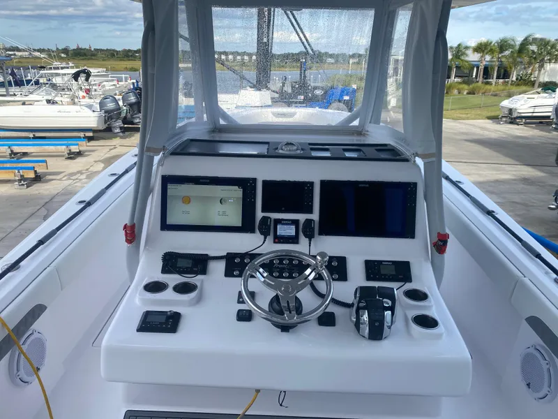 Slide: The Image of Control console of a 2022 Front Runner 36 cc boat, featuring advanced navigation systems. - 12