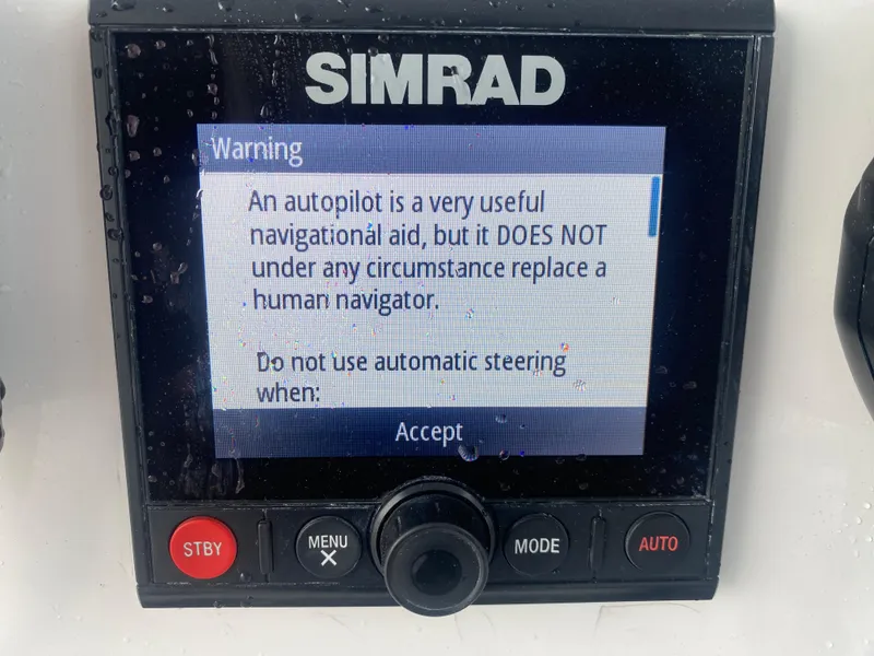 Slide: The Image of Simrad autopilot warning screen on 2022 Front Runner 36 cc boat, cautioning against replacing human navigation. - 14