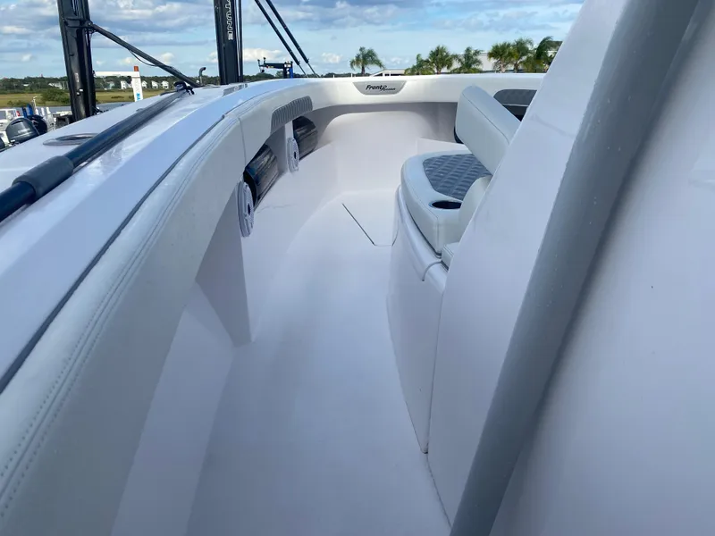 Slide: The Image of 2022 Front Runner 36 cc boat interior with white seating and open deck. - 17