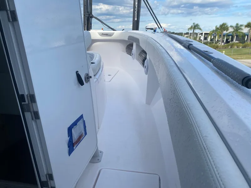 Slide: The Image of 2022 Front Runner 36 cc boat deck with open door, clear sky, and palm trees. - 18