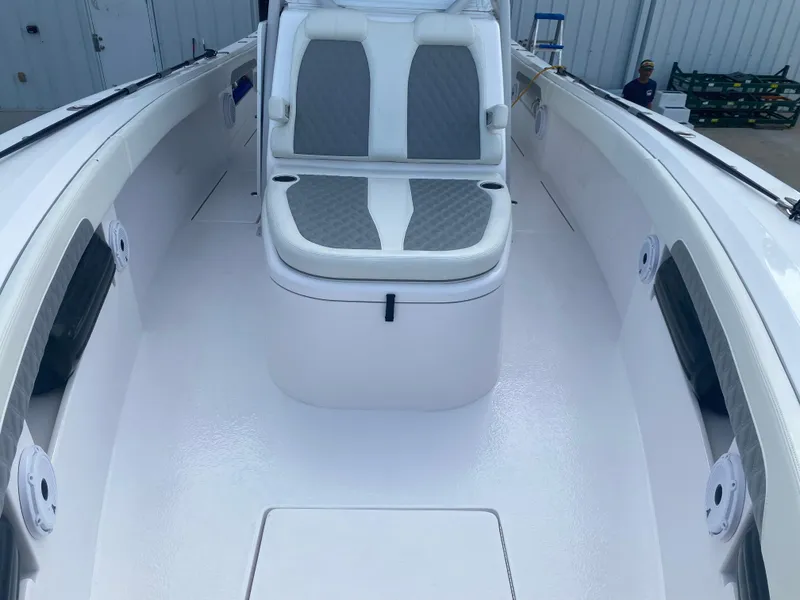 Slide: The Image of 2022 Front Runner 36 cc boat interior with cushioned seating and sleek white design. - 20