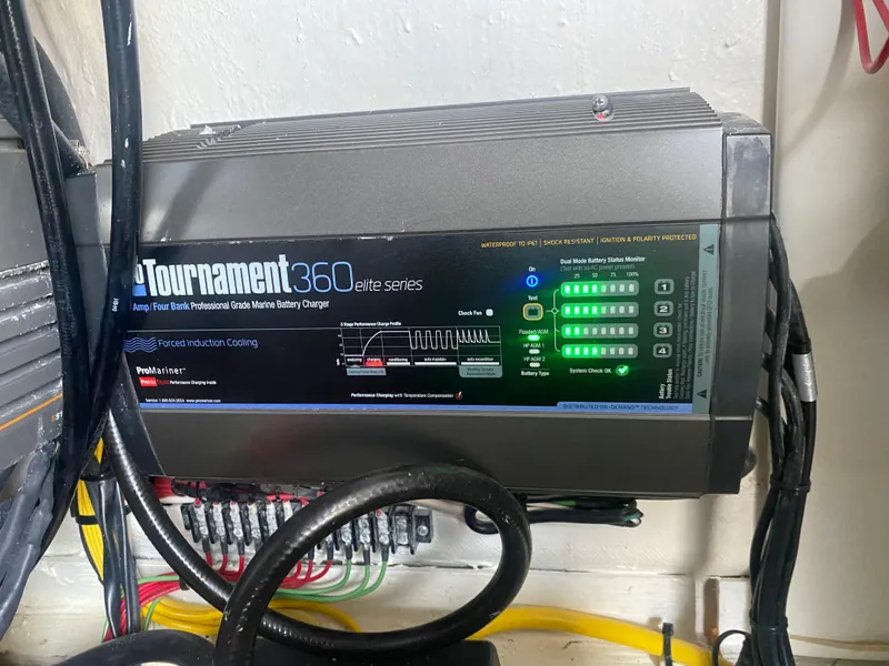 Slide: The Image of Battery charger with LED indicators, labeled "Tournament 360 Elite Series," mounted on a wall. - 23