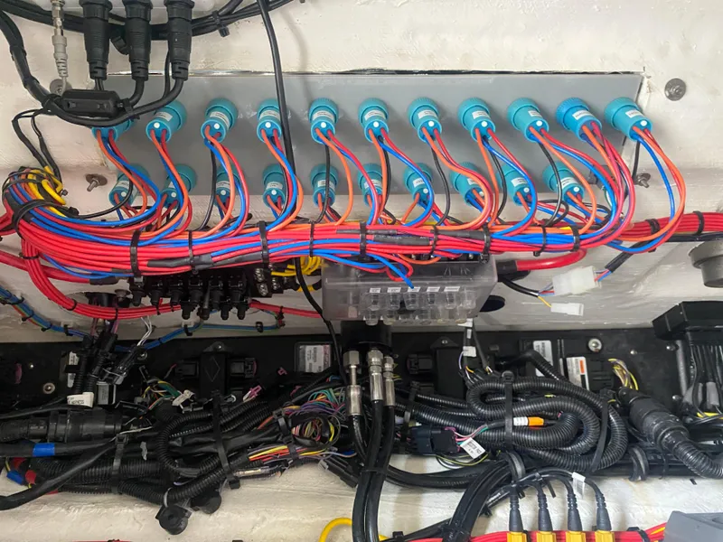 Slide: The Image of Electrical wiring system in a 2022 Front Runner 36 cc boat, showcasing organized cables and connectors. - 25