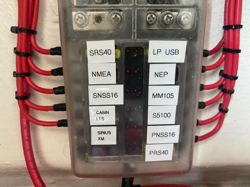 Slide: The Image of Electrical panel with labeled switches and red wires, Front Runner 36 cc, 2022 model. - 27
