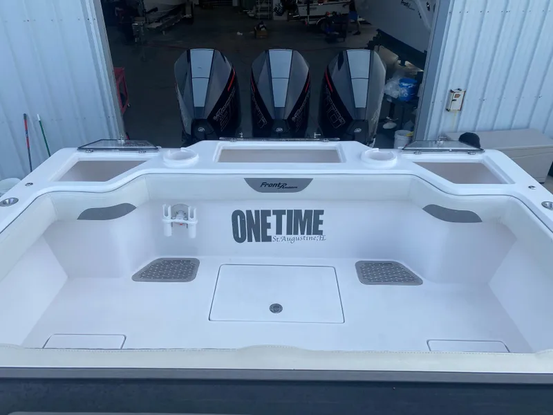 Slide: The Image of 2022 Front Runner 36 cc boat deck with "ONETIME" branding, featuring spacious layout and storage. - 6