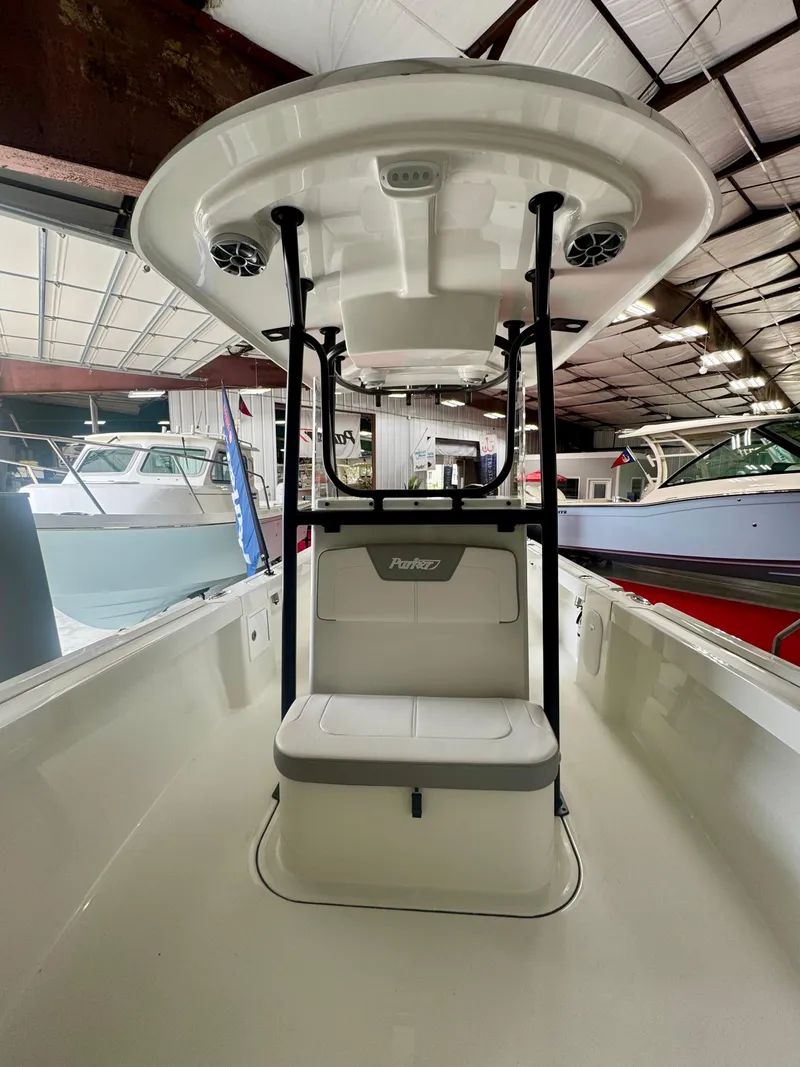 Slide: The Image of 2025 Parker 23SE Center Console boat in a showroom, featuring a sleek design. - 10