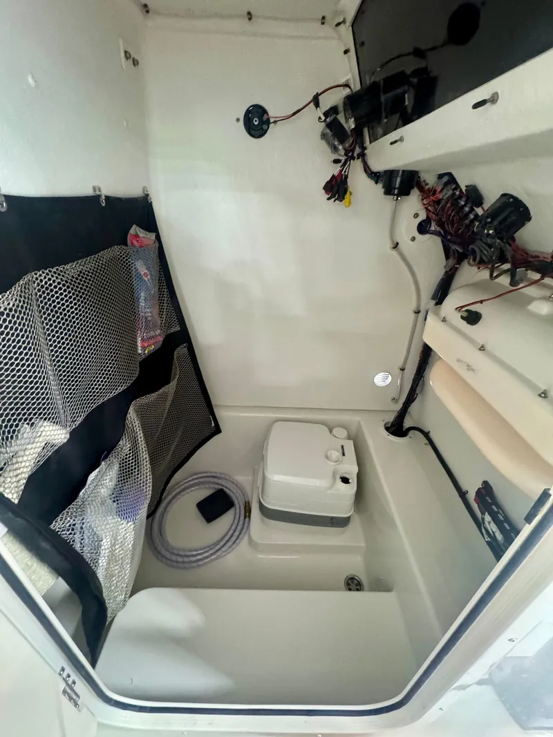 Slide: The Image of 2025 Parker 23SE Center Console boat interior with storage and wiring. - 12