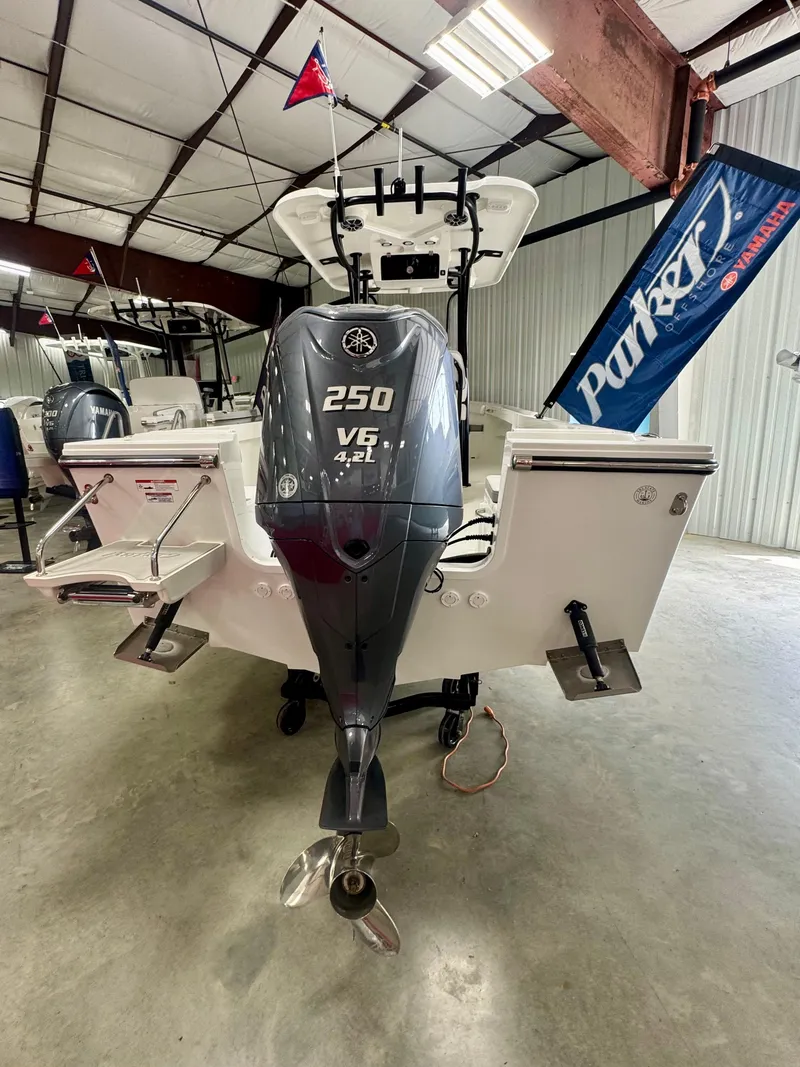 Slide: The Image of 2025 Parker 23SE Center Console boat with Yamaha 250 V6 engine in a showroom. - 3