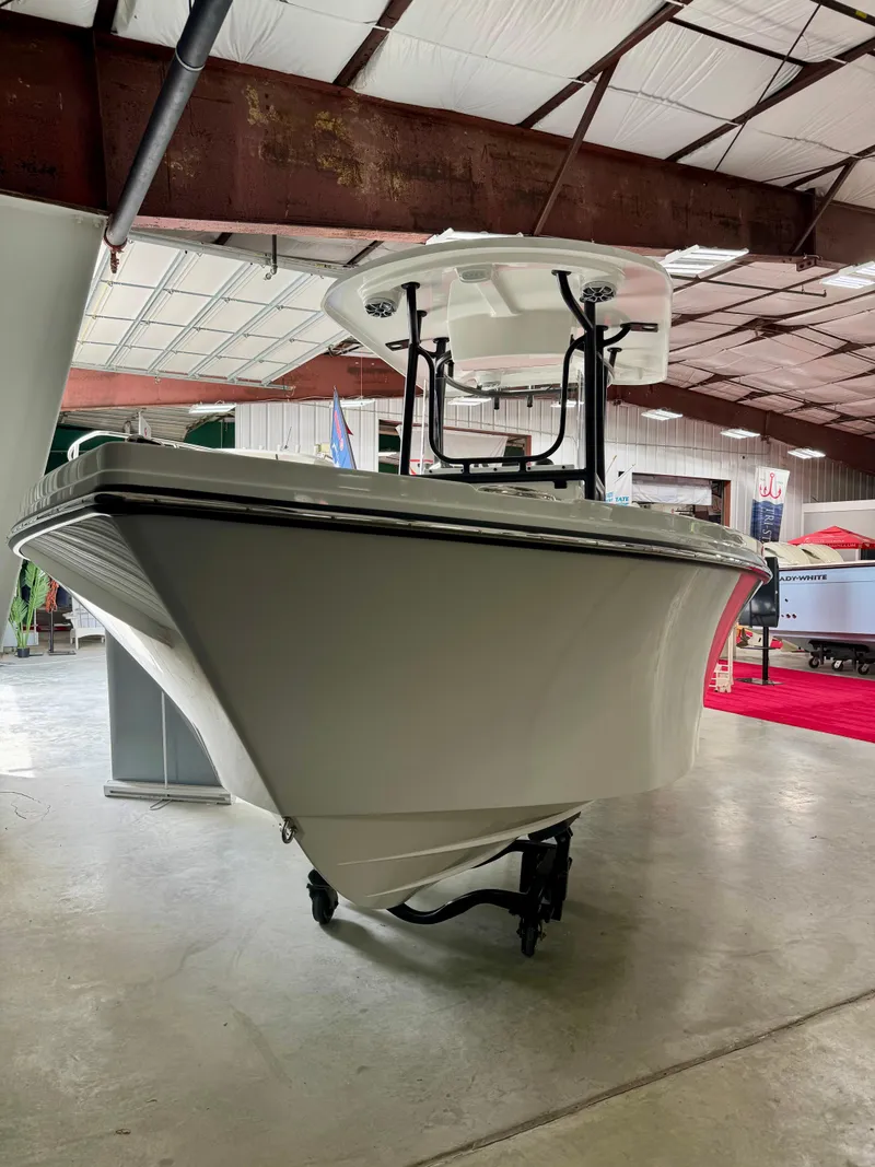 Slide: The Image of 2025 Parker 23SE Center Console boat displayed in a spacious indoor showroom. - 4