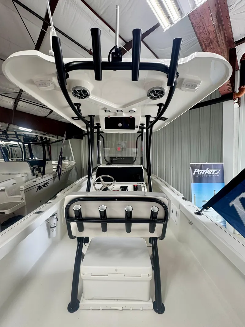 Slide: The Image of 2025 Parker 23SE Center Console boat in showroom, featuring modern design and equipment. - 7