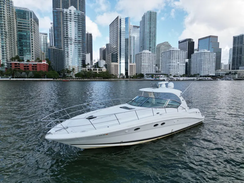 Slide: The Image of 2005 Sea Ray 44 Sundancer yacht cruising near city skyline. - 1