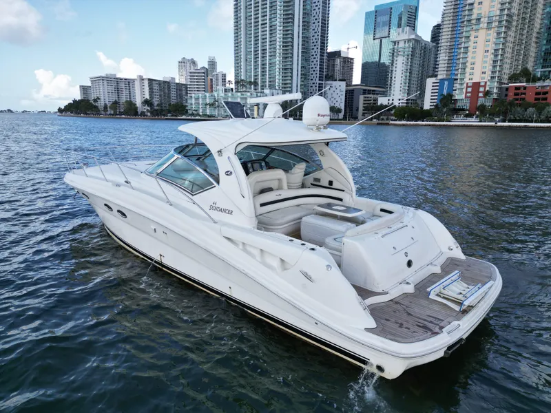 Slide: The Image of 2005 Sea Ray 44 Sundancer yacht cruising near city skyline. - 10
