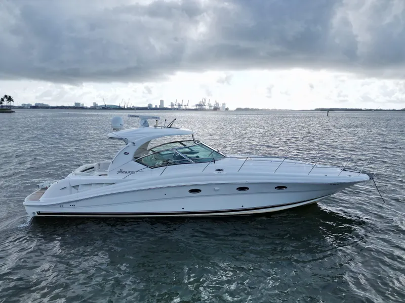 Slide: The Image of 2005 Sea Ray 44 Sundancer yacht on calm waters under cloudy skies. - 3