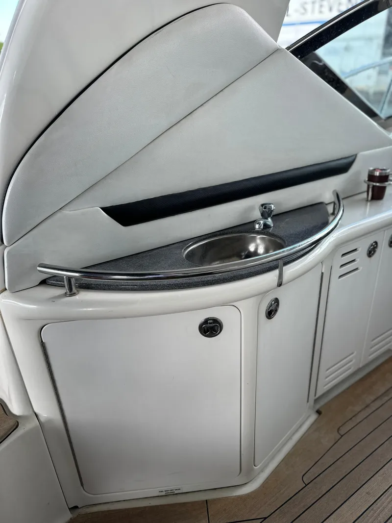 Slide: The Image of 2005 Sea Ray 44 Sundancer yacht interior with sink and storage cabinets. - 35