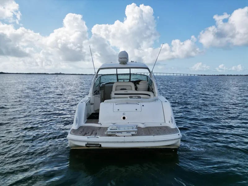 Slide: The Image of 2005 Sea Ray 44 Sundancer yacht on open water under a blue sky. - 6