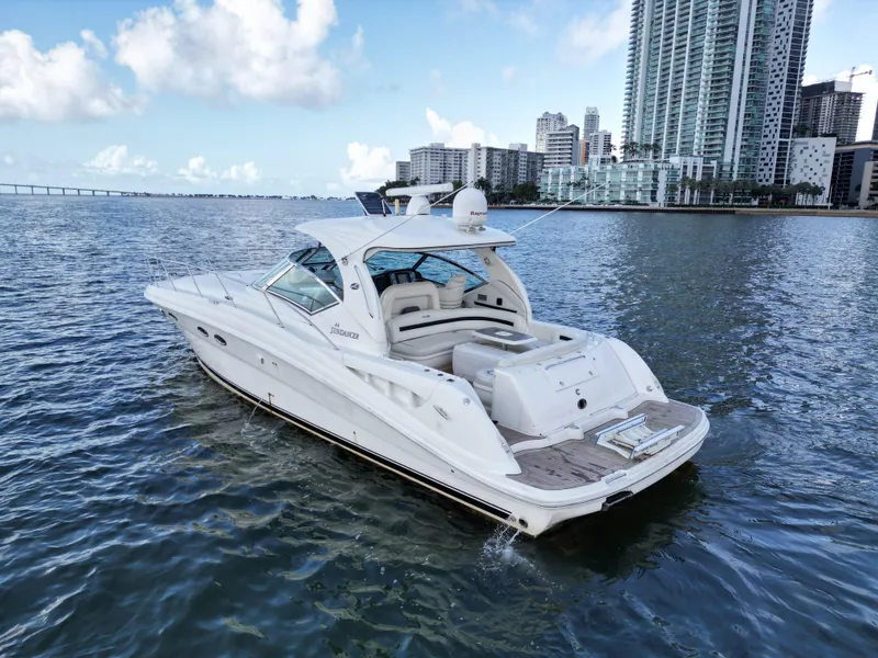 Slide: The Image of 2005 Sea Ray 44 Sundancer yacht cruising near city skyline on a sunny day. - 8