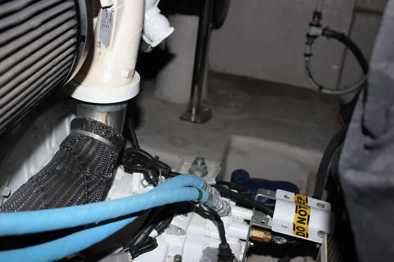 Slide: The Image of Engine compartment of 2017 Sea Ray Sundancer 400 with visible hoses and components. - 11