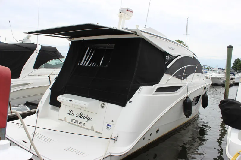 Slide: The Image of 2017 Sea Ray Sundancer 400 yacht docked with black canopy and sleek design. - 20