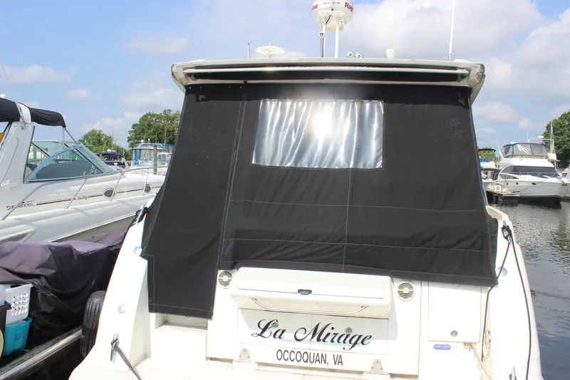 Slide: The Image of 2017 Sea Ray Sundancer 400 docked, rear view with black cover, named "La Mirage." - 26