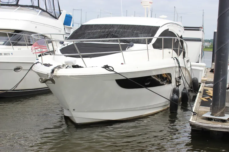 Slide: The Image of 2017 Sea Ray Sundancer 400 yacht docked at marina, featuring sleek white design. - 3