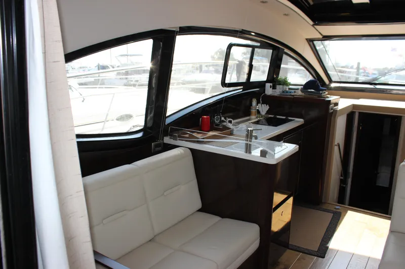 Slide: The Image of 2017 Sea Ray Sundancer 400 interior with modern kitchen and seating area. - 33