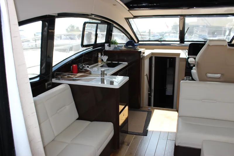 Slide: The Image of Interior of 2017 Sea Ray Sundancer 400 yacht with modern seating and kitchenette. - 47