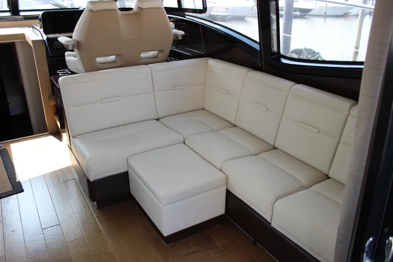 Slide: The Image of Luxurious interior of 2017 Sea Ray Sundancer 400 with cream leather seating and wood flooring. - 48