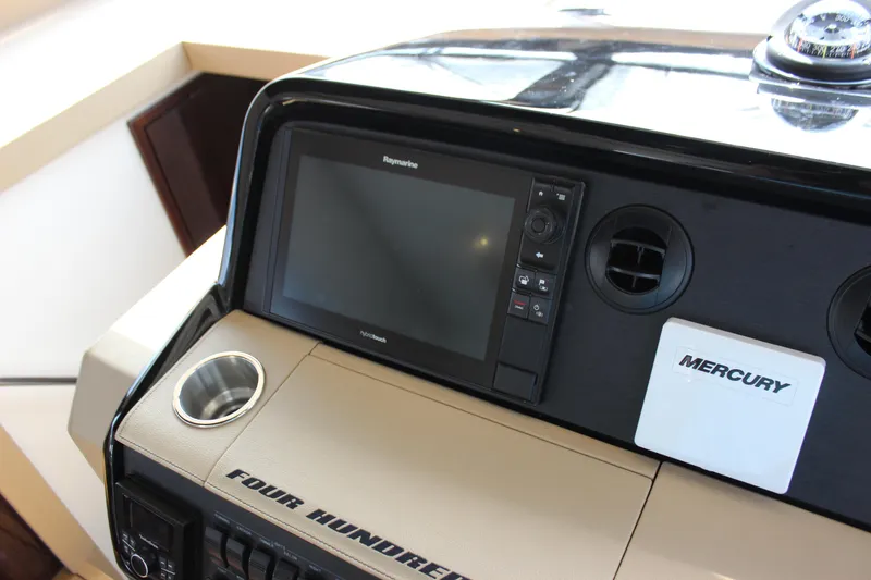 Slide: The Image of 2017 Sea Ray Sundancer 400 helm with Raymarine display and Mercury controls. - 49