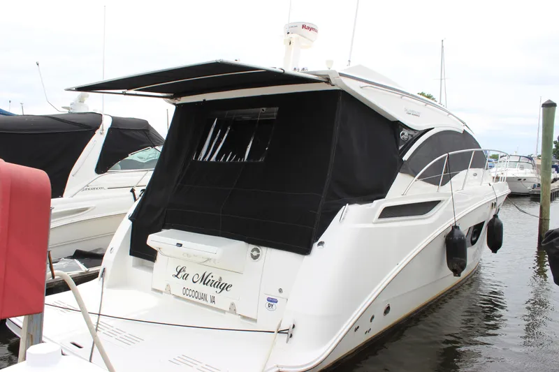 Slide: The Image of 2017 Sea Ray Sundancer 400 yacht docked with black canopy and sleek design. - 5