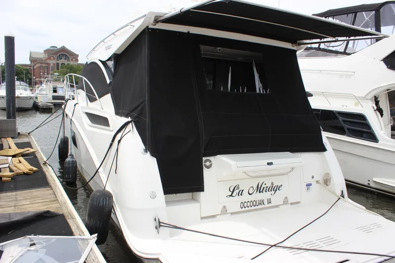 Slide: The Image of 2017 Sea Ray Sundancer 400 docked, featuring black canvas cover, named "La Mirage." - 7