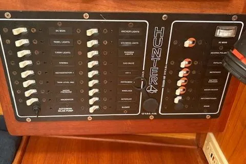 Slide: The Image of Control panel of a 2001 Hunter 340 sailboat with labeled switches and indicators. - 10