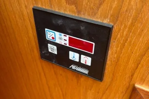 Slide: The Image of Control panel on a 2001 Hunter 340 boat, featuring temperature and fan settings. - 15