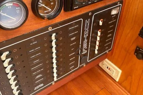 Slide: The Image of Control panel of a 2001 Hunter 340 sailboat with gauges and switches. - 16