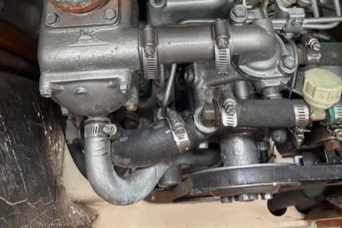 Slide: The Image of Engine components of a 2001 Hunter 340 boat, featuring hoses and metal fittings. - 23