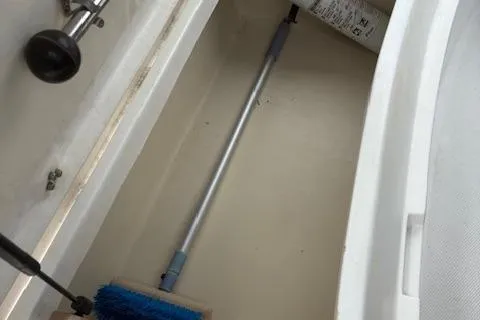 Slide: The Image of Storage compartment in a 2001 Hunter 340 sailboat with cleaning tools. - 27