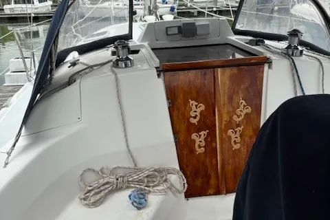 Slide: The Image of 2001 Hunter 340 sailboat cockpit with wooden doors and coiled rope. - 6