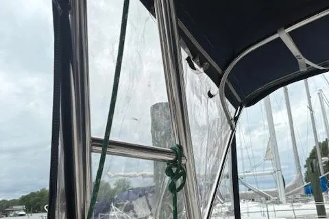 Slide: The Image of Sailboat cockpit with clear enclosure, Hunter 340, 2001 model, marina background. - 7