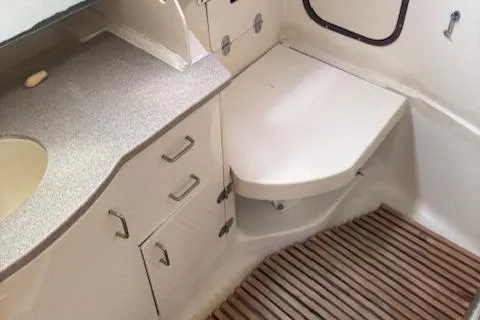 Slide: The Image of 2001 Hunter 340 yacht bathroom with countertop, sink, and wooden floor. - 9