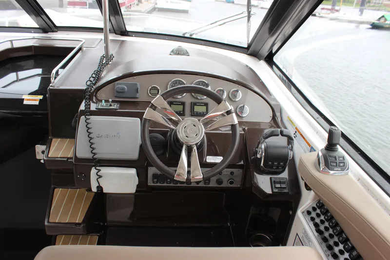 Slide: The Image of Cockpit of 2014 Regal 35 Sport Coupe with modern controls and steering wheel. - 10