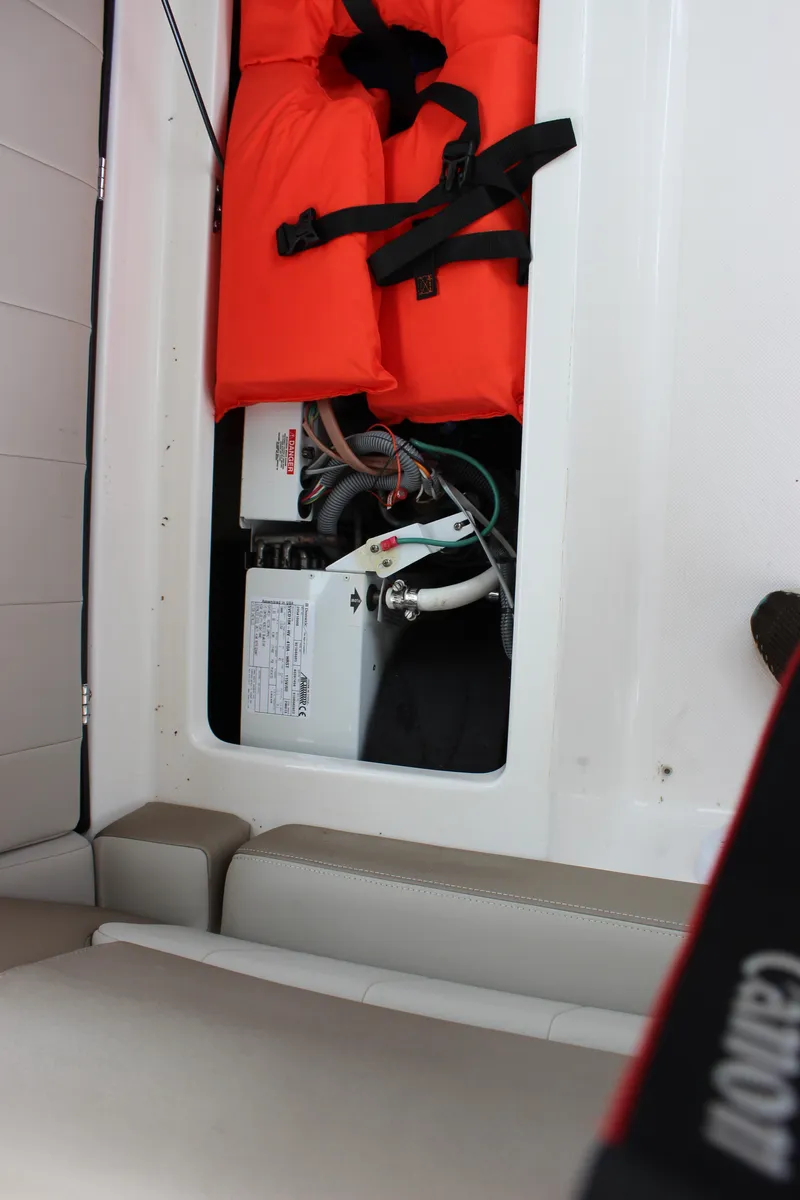 Slide: The Image of Storage compartment in a 2014 Regal 35 Sport Coupe with life jackets and equipment. - 11